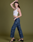Side view of Lazy Daisy Mid-Rise Carpenter Jeans and vintage tee white Cropped Tank on Alex