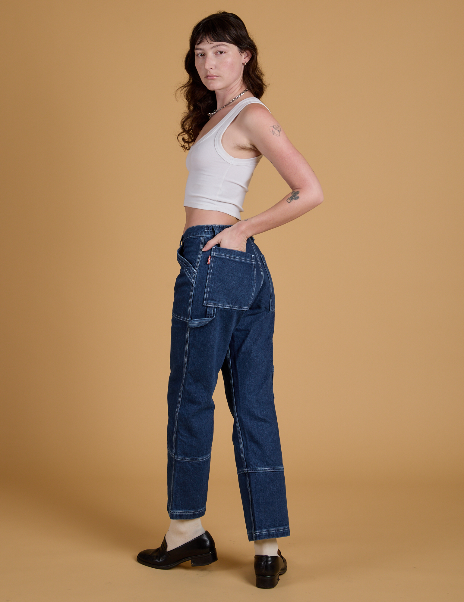 Angled back view of Mid-Rise Carpenter Jeans in Dark Wash on Alex