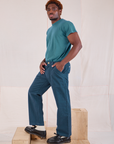 Side view of Mid-Rise Work Pants in Lagoon and marine blue Organic Vintage Tee on Issac
