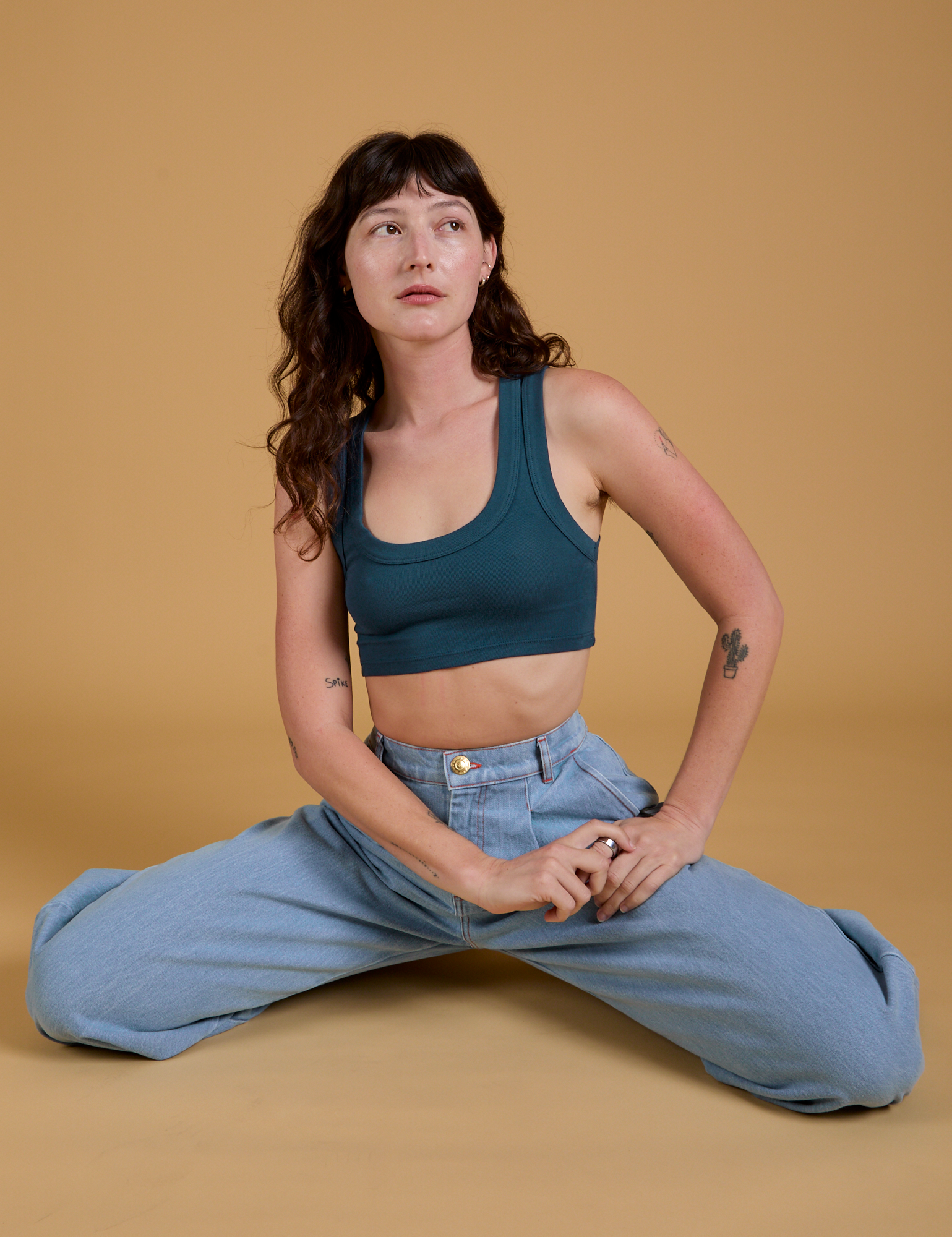 Alex is wearing Mini Tank in Lagoon and light wash Indigo Wide Leg Trousers