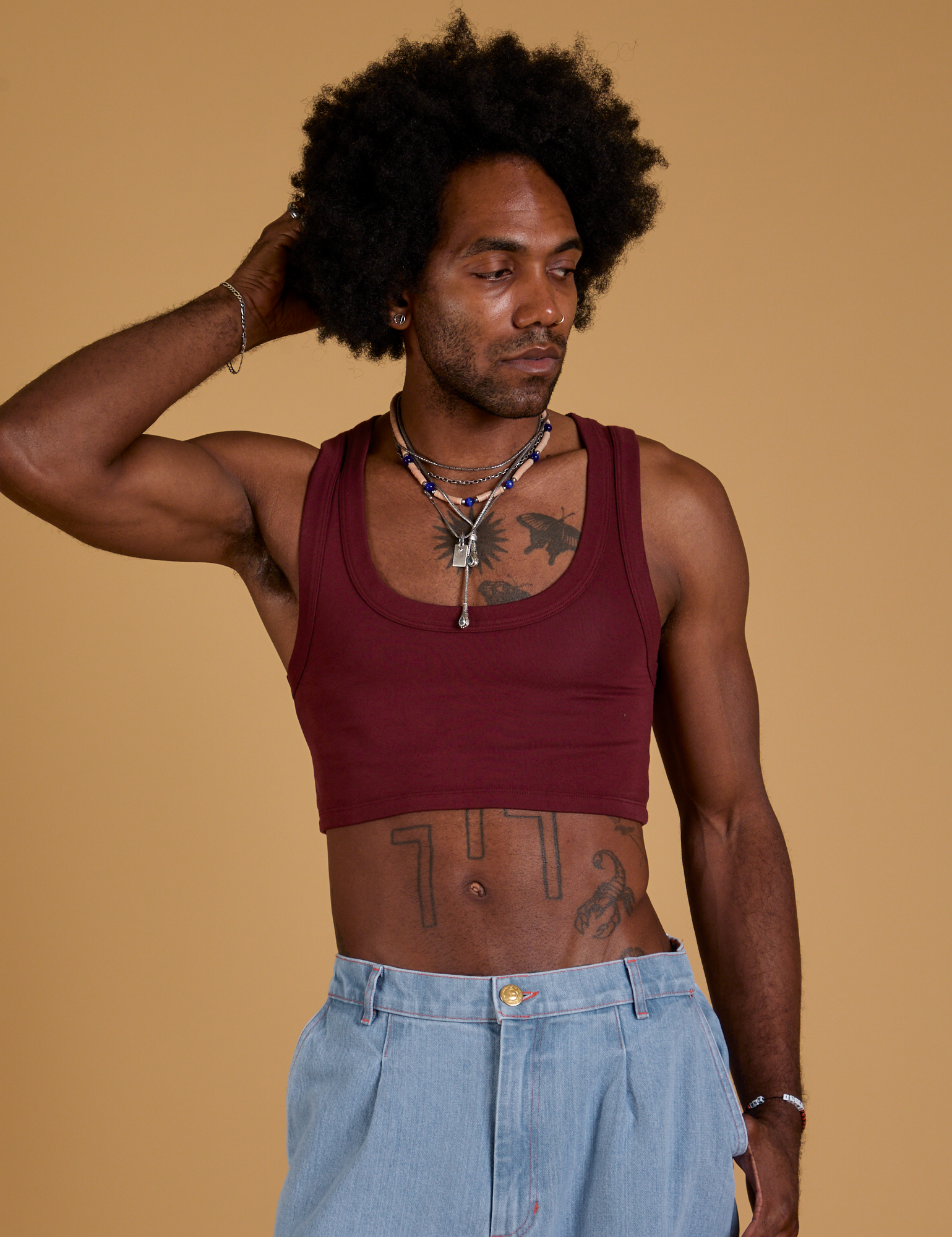 Jerrod is 6’3” and wearing S Mini Tank in Red Wine