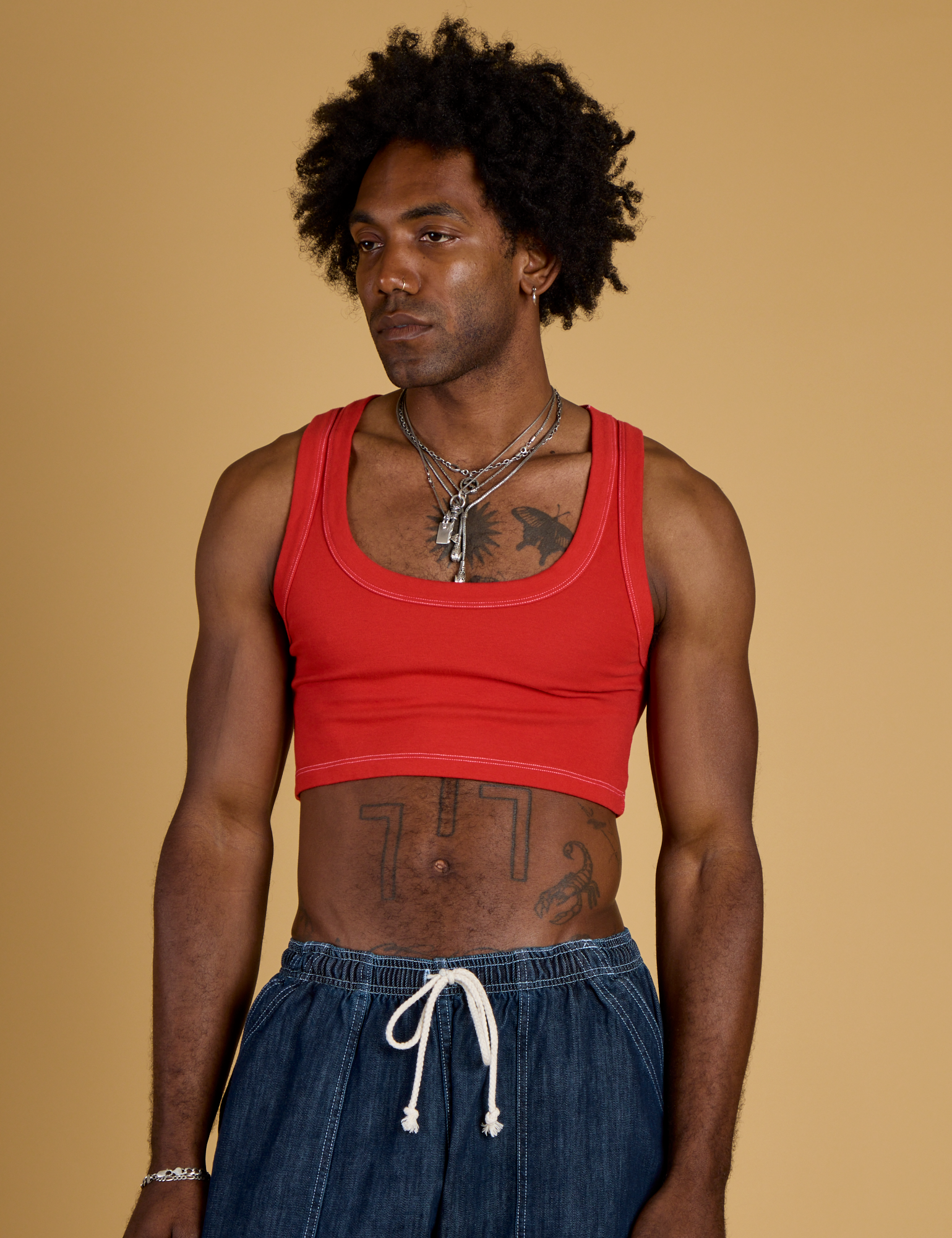 Jerrod is 6’3” and wearing M Contrast Stitch Mini Tank in Mustang Red