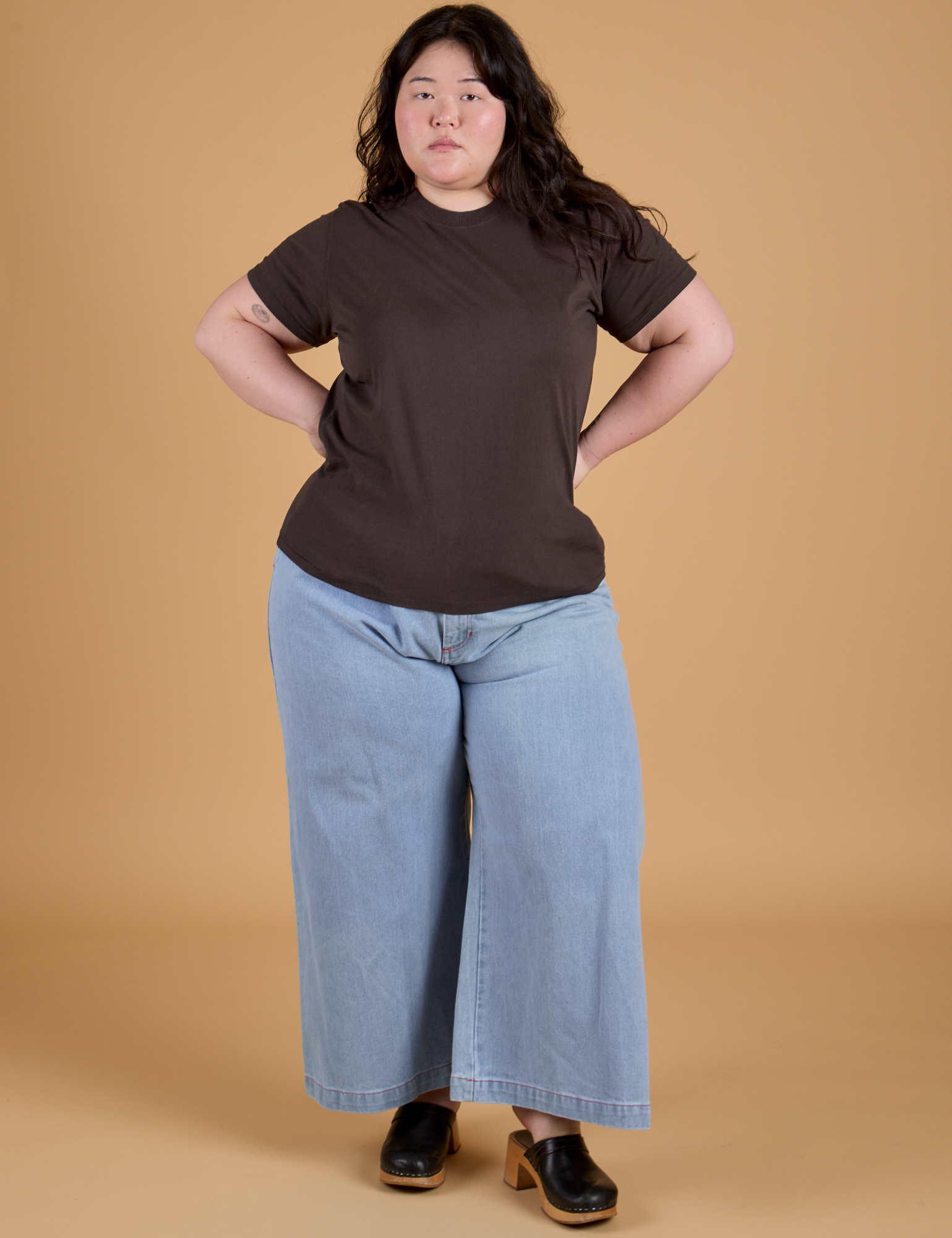 Ashley is wearing Organic Vintage Tee in Espresso Brown paired with light wash Indigo Wide Leg Trousers