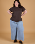 Ashley is wearing Organic Vintage Tee in Espresso Brown paired with light wash Indigo Wide Leg Trousers