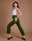 Side view of Organic Work Pants in Evergreen and vintage tee white Cropped Tank on Alex