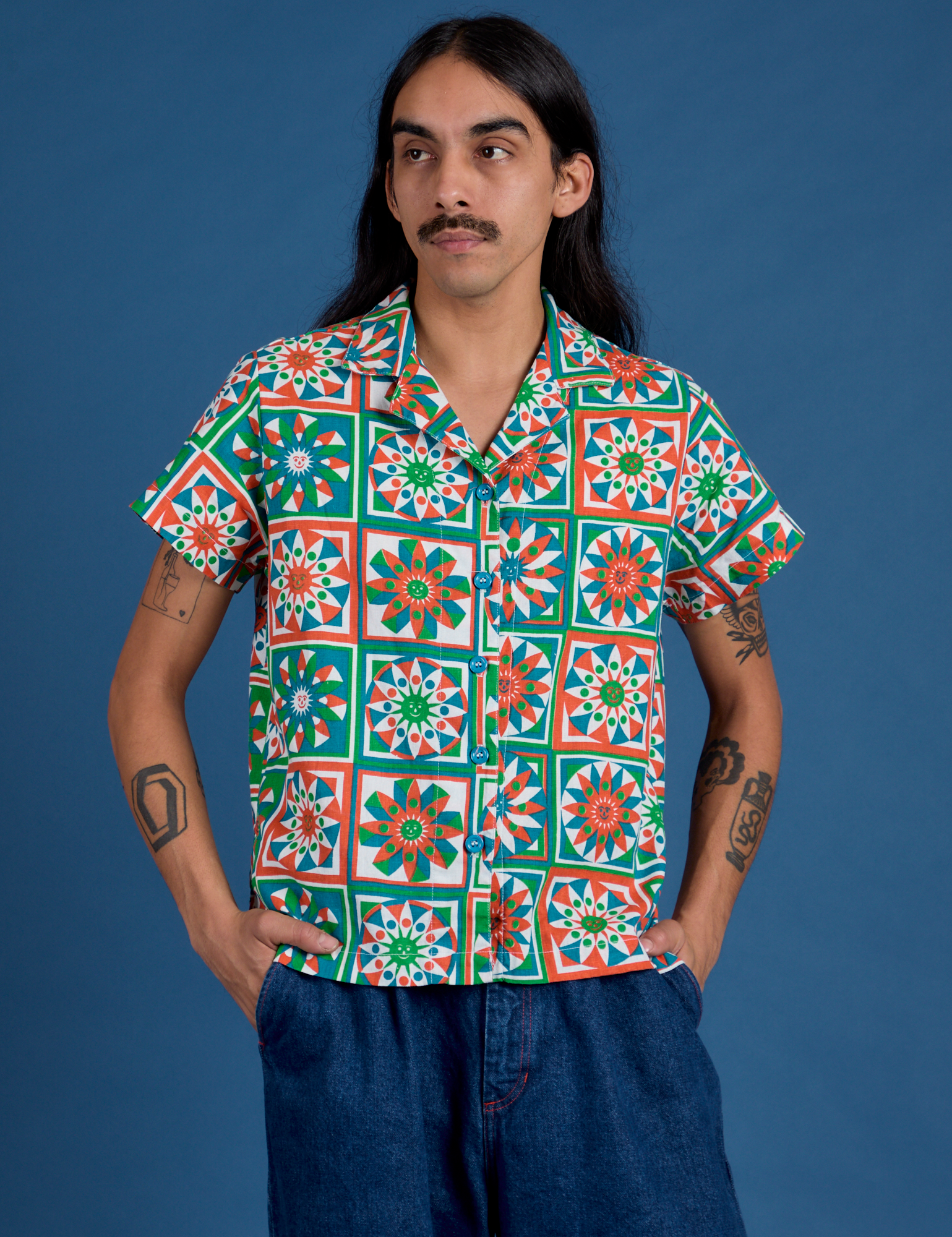 Anthony is wearing a buttoned up Quilt Print Pantry Button-Up