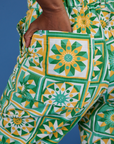 Close up of Kandia's hand in the back pocket of Spring Quilt Print Jumpsuit
