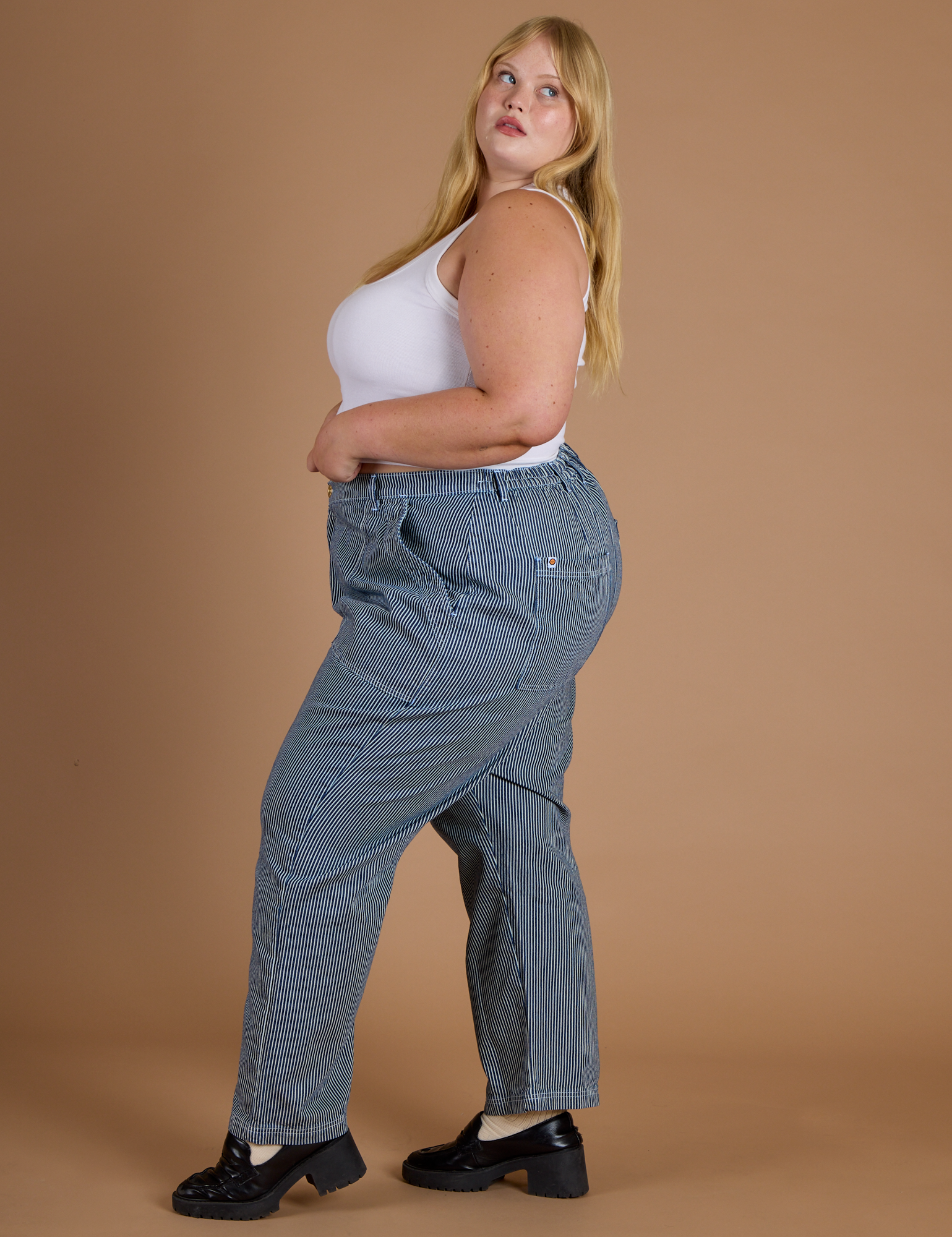 Side view of Railroad Denim Work Pants in Natural and vintage tee white Cropped Tank on Juliet