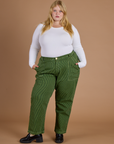 Juliet is 5’7” and wearing 2XL Railroad Denim Work Pants in Gross Green Overdye paired with vintage tee white Long Sleeve Baby Tee