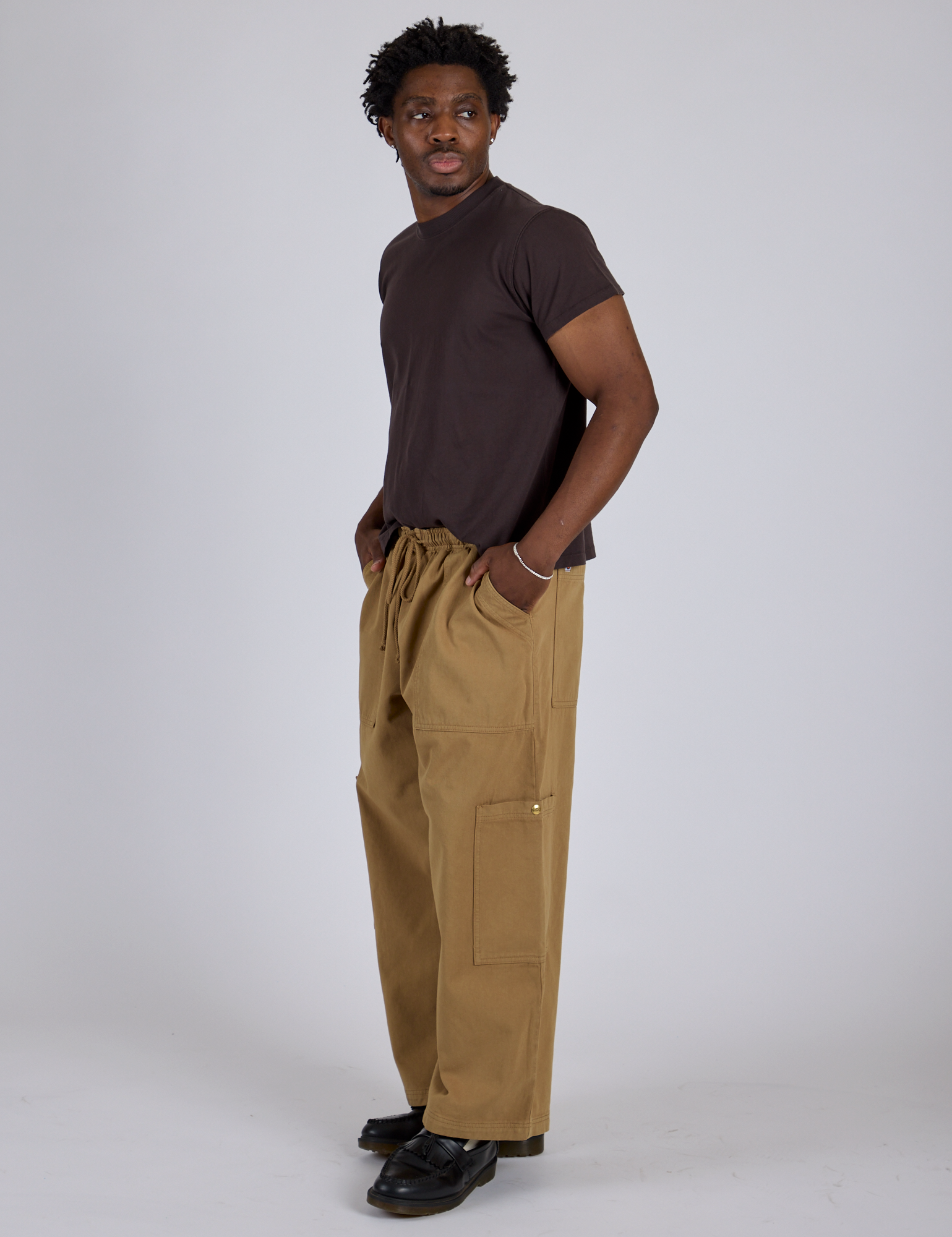 Side view of Drop Pocket Cargo Pants in Desert Brown and espresso brown Organic Vintage Tee on Isaac