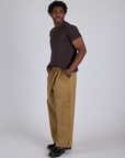 Side view of Drop Pocket Cargo Pants in Desert Brown and espresso brown Organic Vintage Tee on Isaac