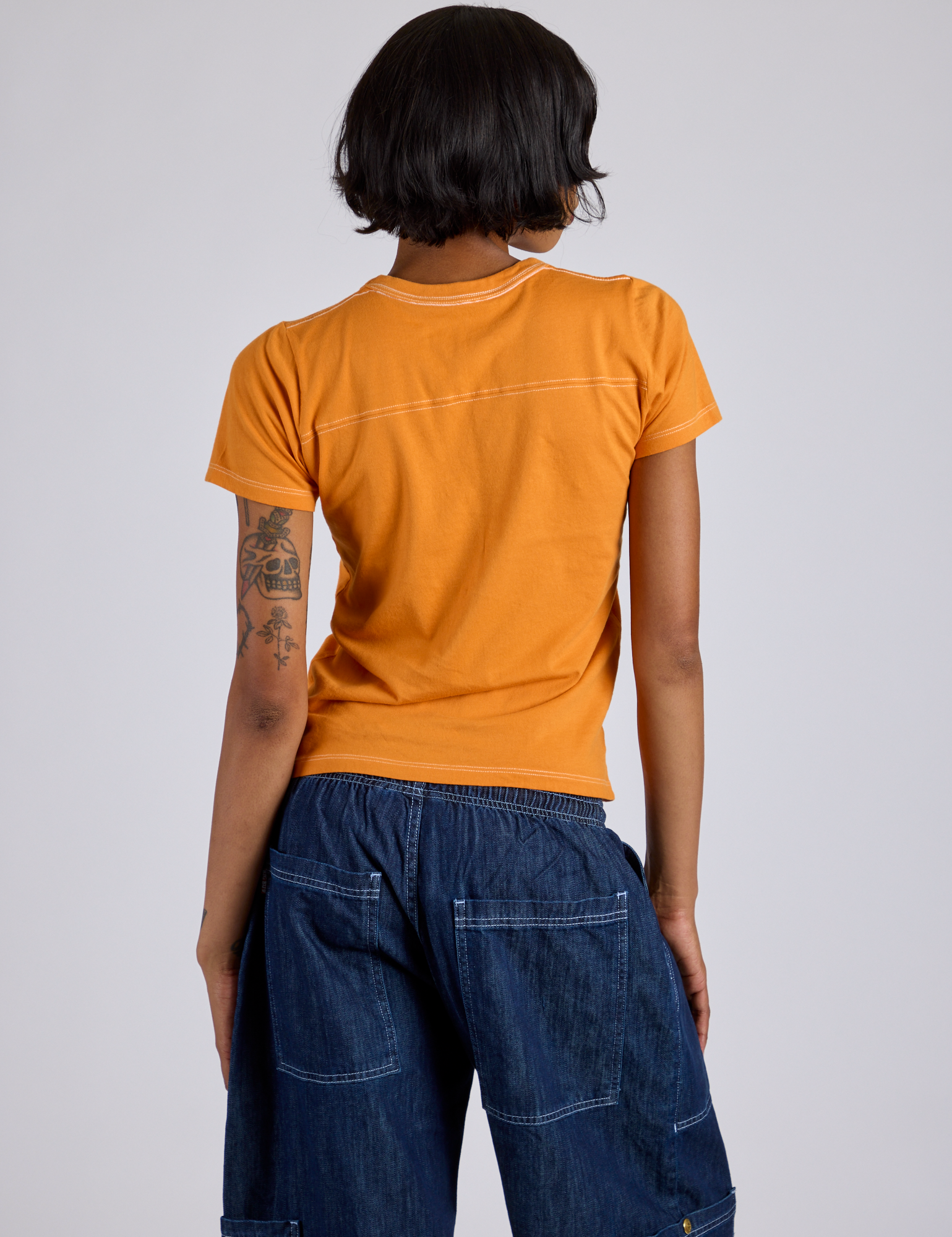 Jr. Varsity Tee in Creamsicle Orange back view on Kira