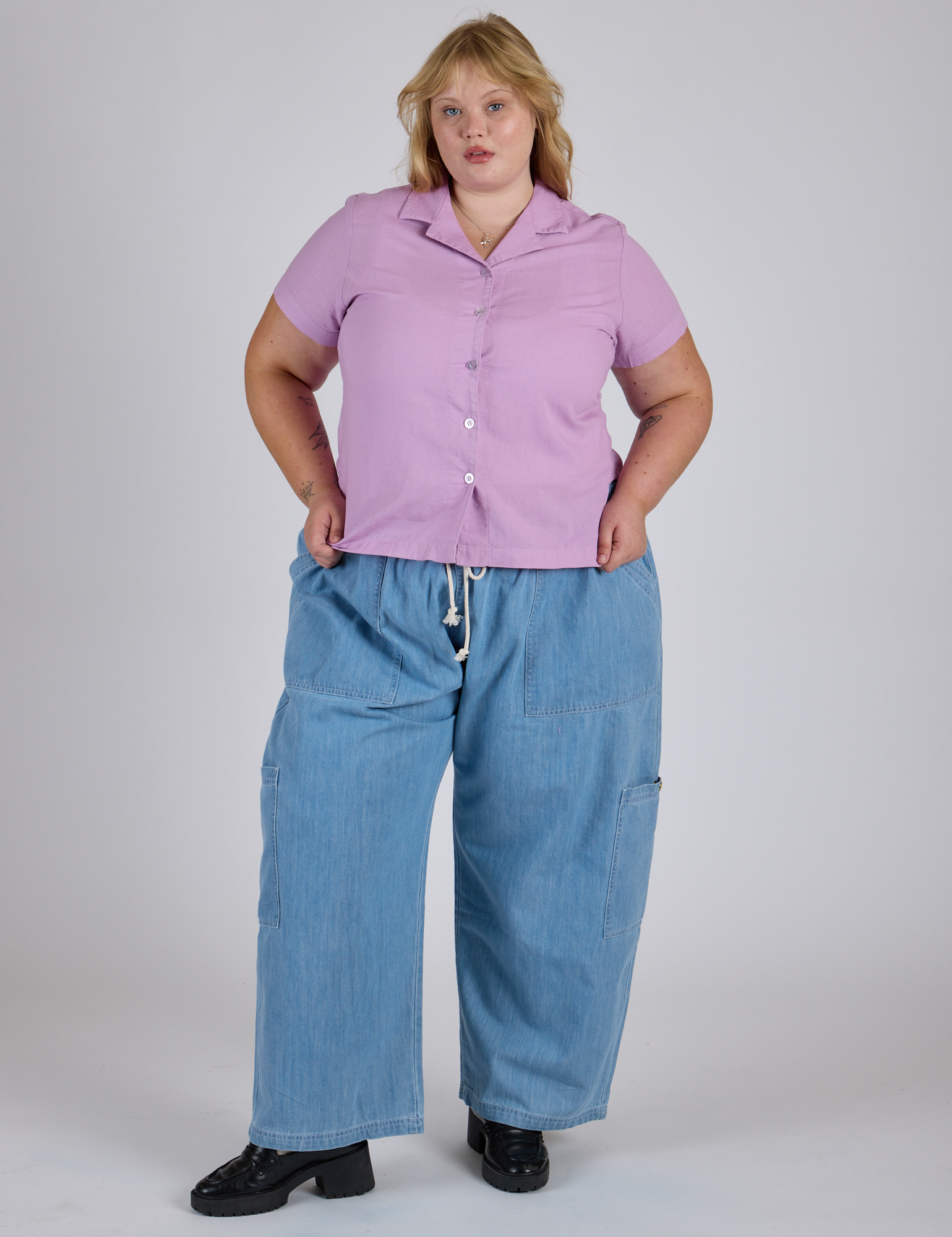 Juliet is 5’7” and wearing L Pantry Button-Up in Lilac Purple paired with light wash Denim Drop Pocket Pants