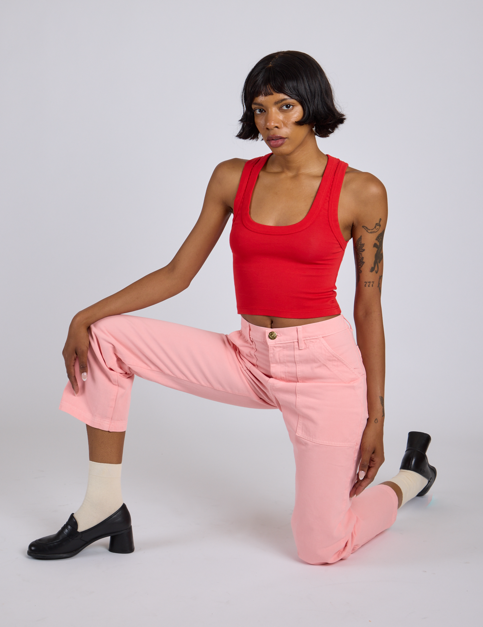 Kira is wearing Work Pants in Baby Pink and mustang red Cropped Tank