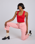 Kira is wearing Work Pants in Baby Pink and mustang red Cropped Tank