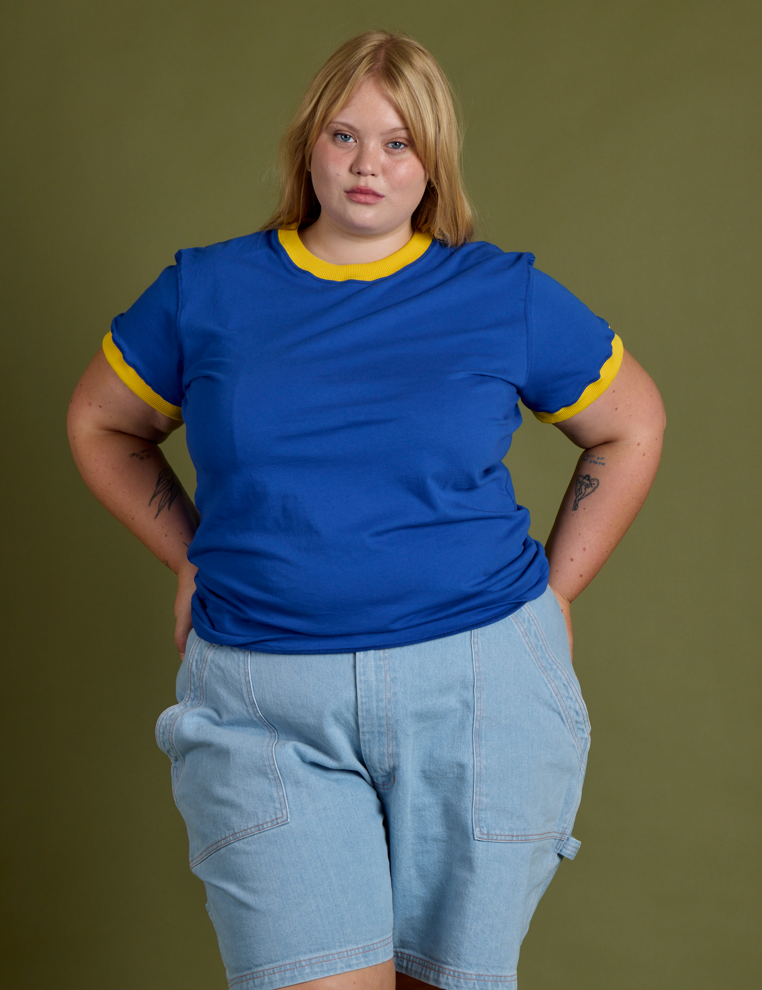 Juliet is 5’7” and wearing L Vintage Ringer Tee in Royal Blue paired with light wash Carpenter Shorts