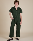 Quinn is 6'3" and wearing L Short Sleeve Jumpsuit in Swamp Green