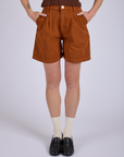 Pleated Trouser Shorts in Burnt Terracotta front close up on Alex
