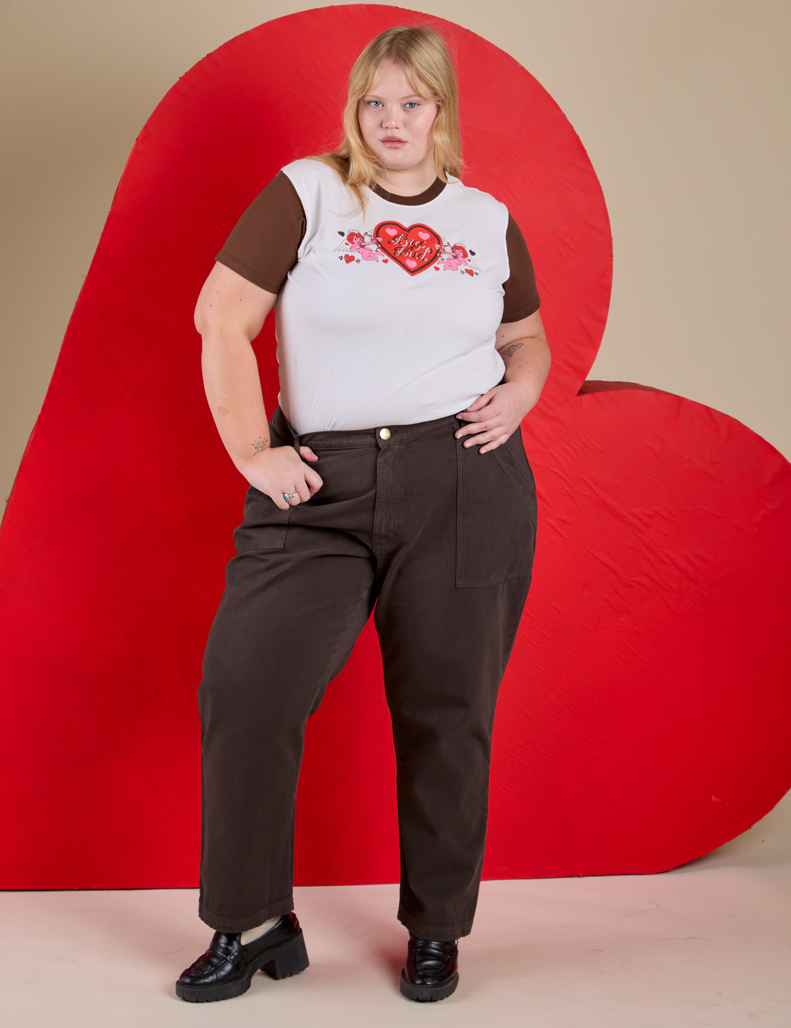 Juliet is 5’7” and wearing L Vintage Tee in Love Big Bud paired with fudgesicle brown Work Pants