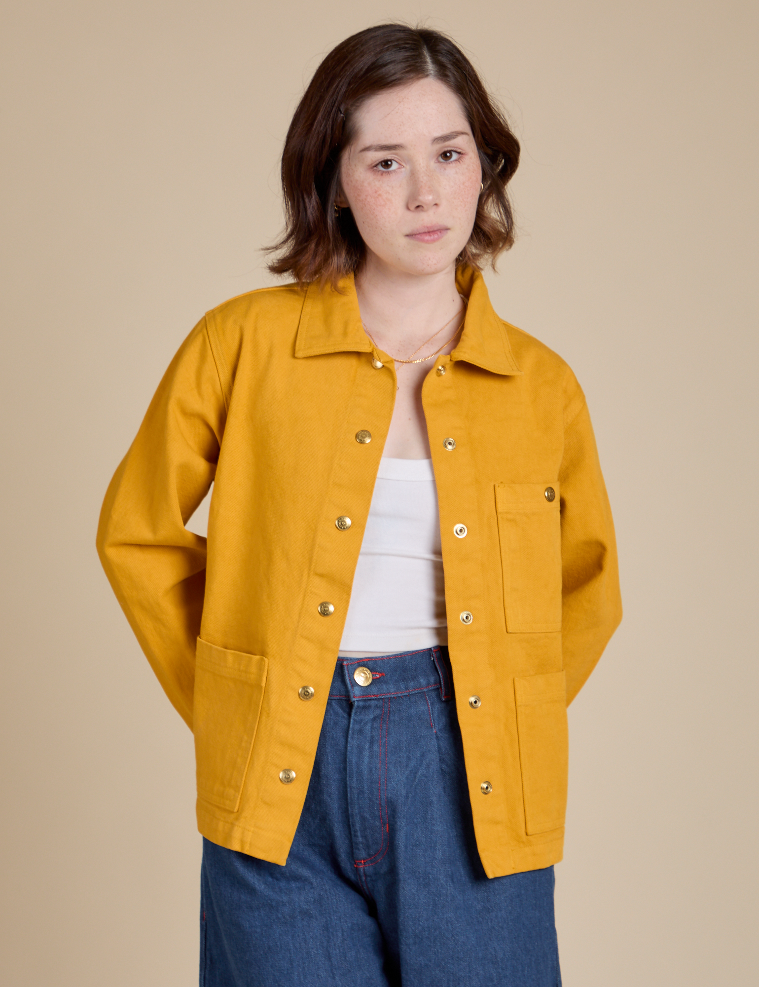 Hana is 5'3" and wearing P Denim Work Jacket in Mustard Yellow