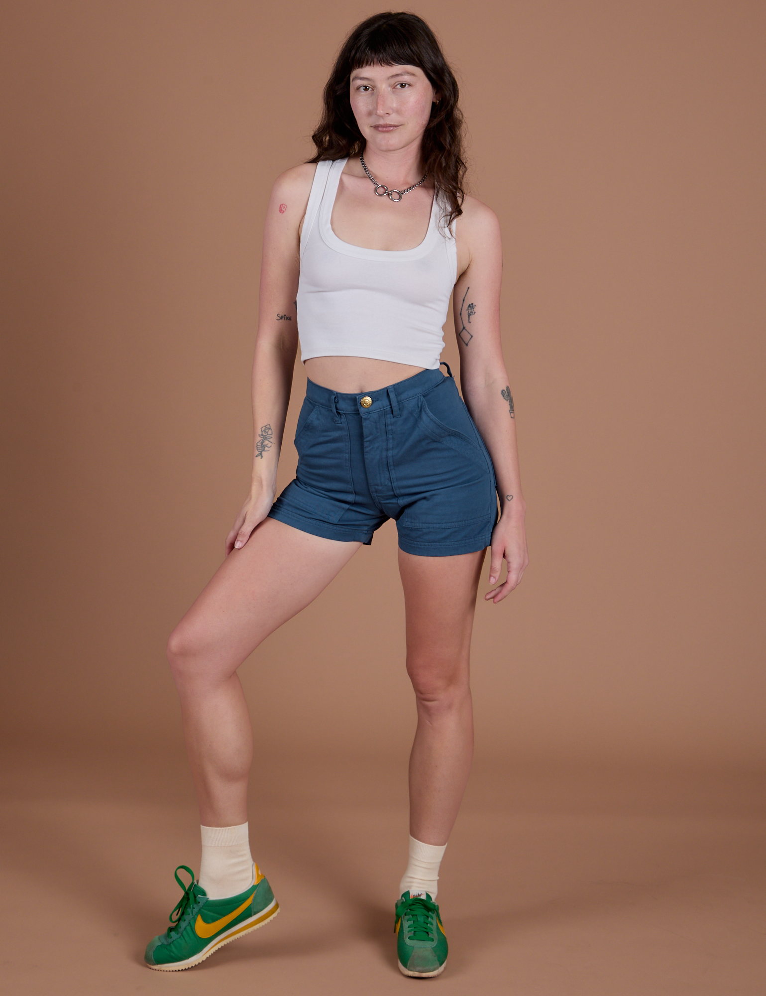 Alex is 5’8” and wearing XXS Classic Work Shorts in French Blue paired with Cropped Tank in Vintage Tee White 