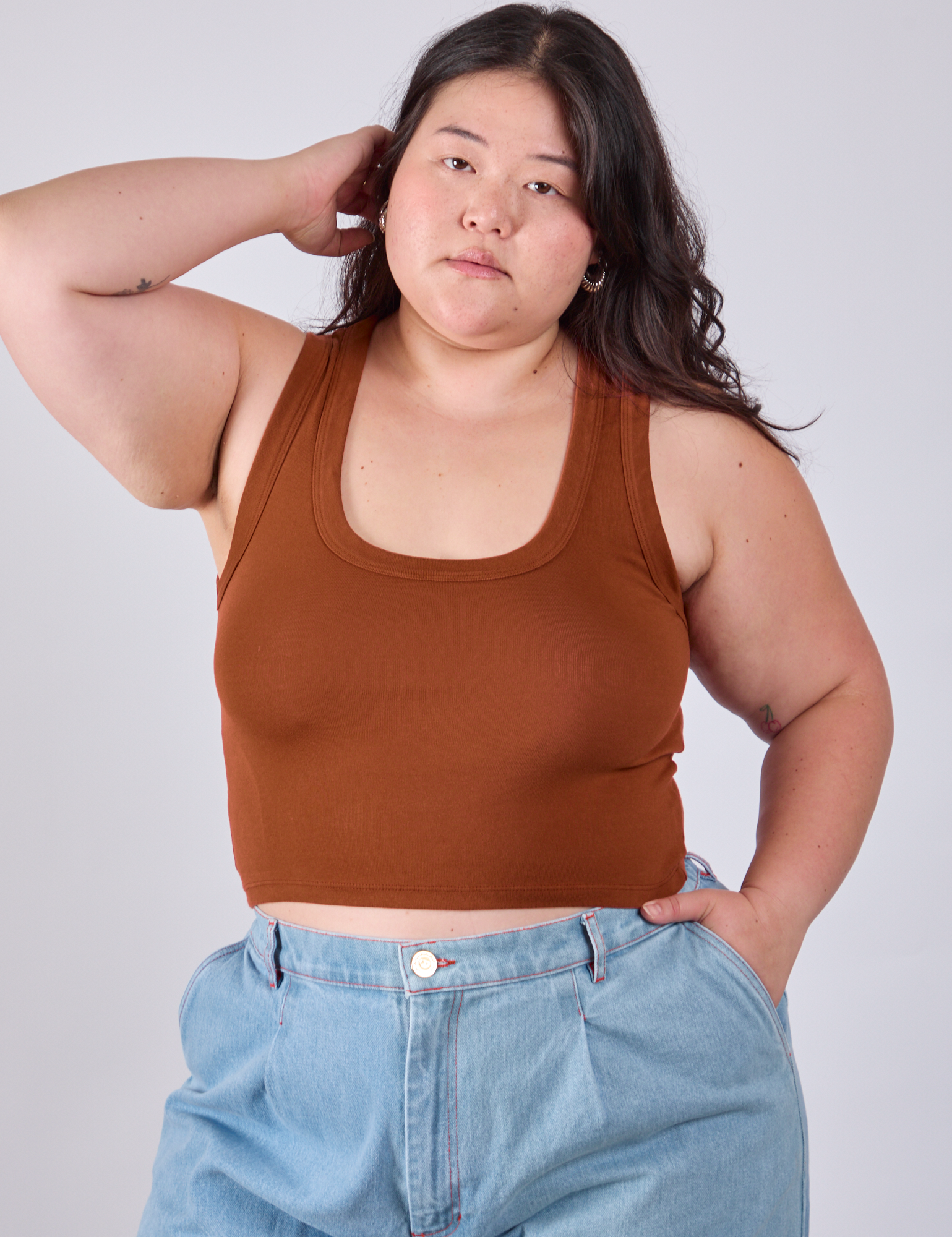 Ashley is 5'7" and wearing L Cropped Tank Top in Burnt Terracotta
