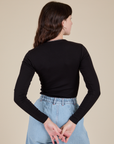 Long Sleeve Baby Tee in Basic Black back view on Alex