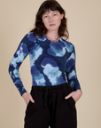 Alex is 5’8” and wearing P Long Sleeve Baby Tee in Blue Magic Waters