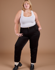 Juliet is 5'8" and wearing 1X Organic Work Pants in Basic Black paired with a vintage tee white Cropped Tank