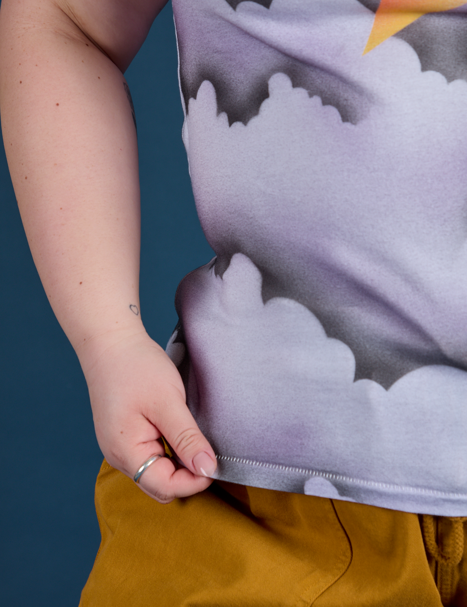 Ashley is holding the hem of Airbrush Star Vintage Tee