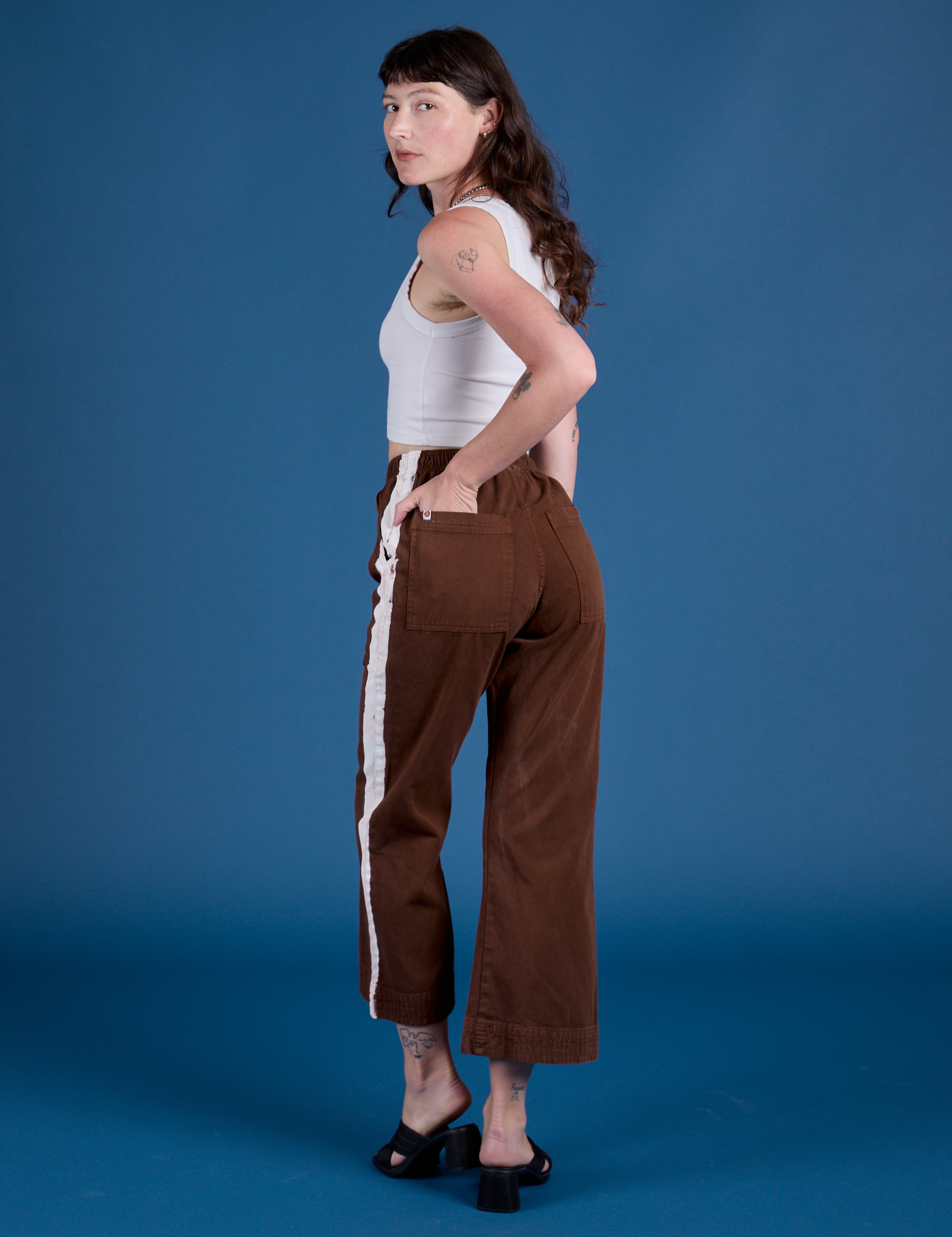 Painted Action Pants in Fudgesicle Brown angled back view on Alex