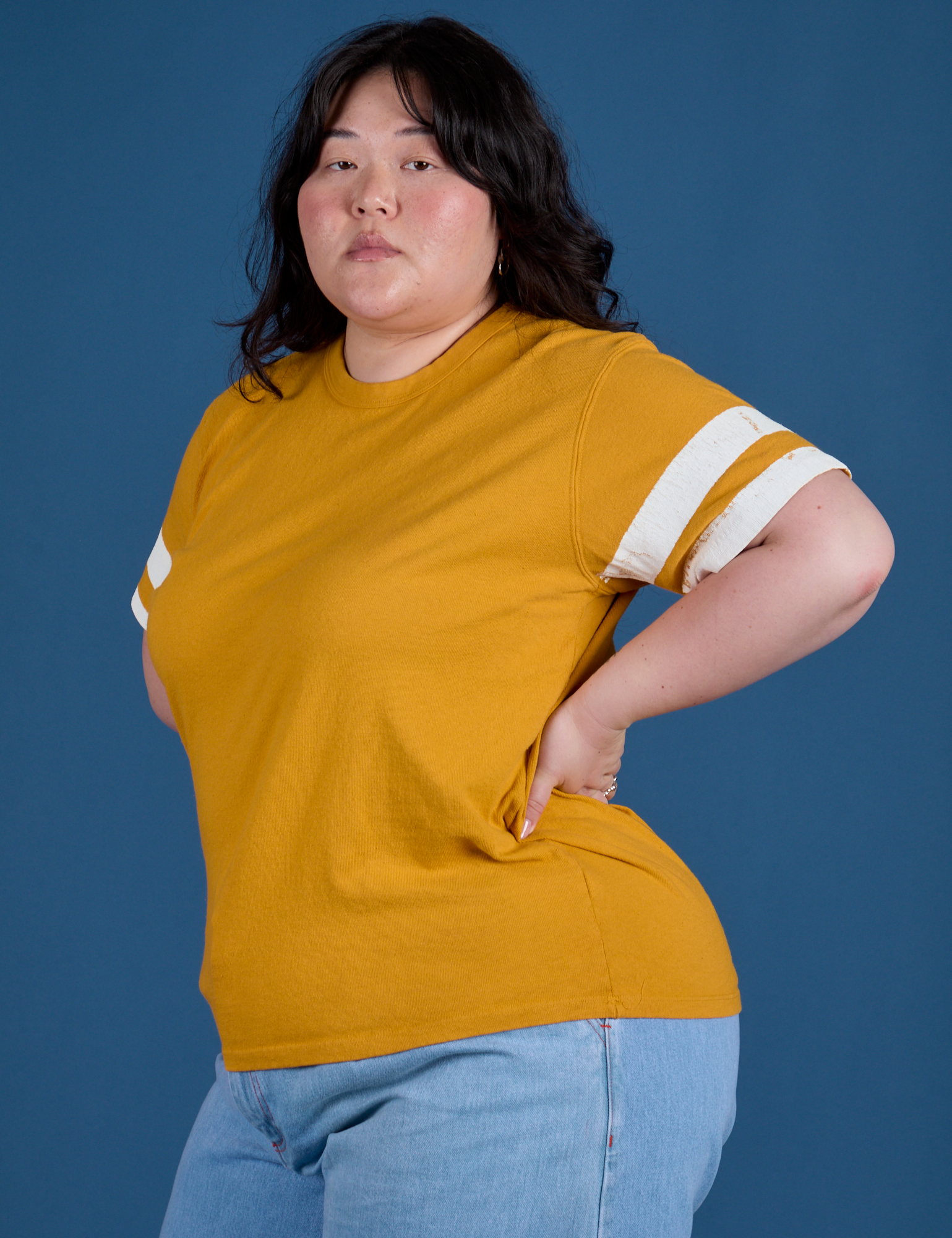 Painted Burly Tee in Mustard Yellow angled front view on Ashley