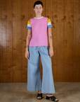 Alex is 5'8" and wearing P Calypso Tee in Bubblegum Multi paired with light wash wide leg denim trousers