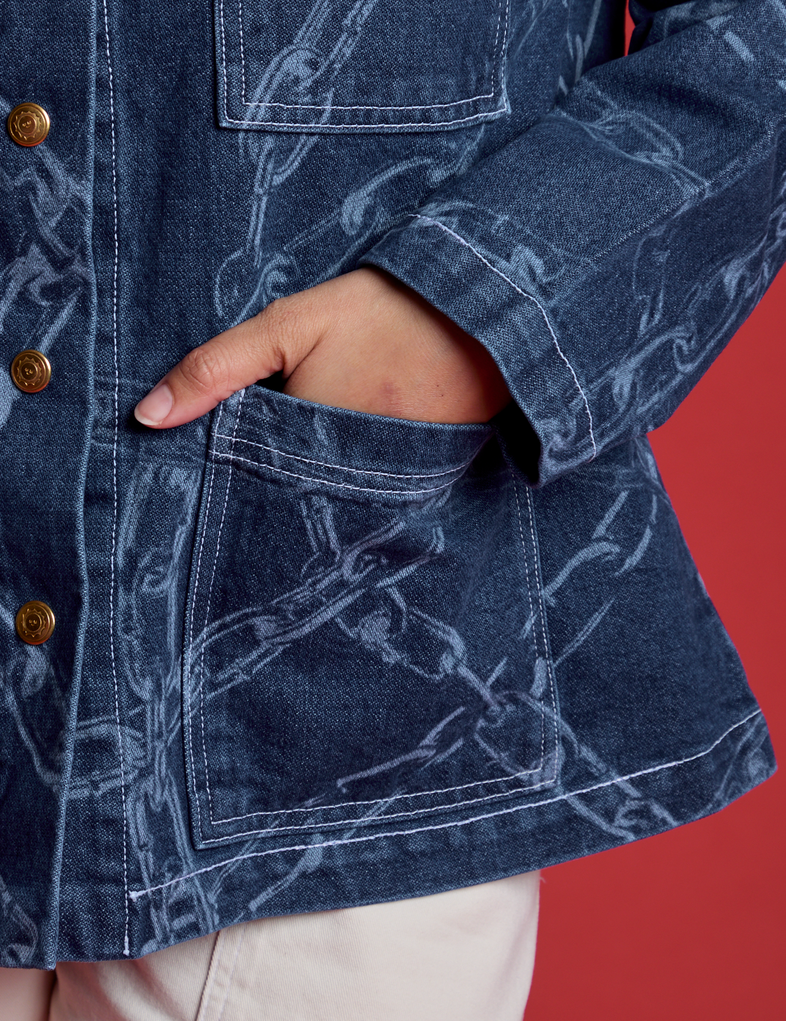 Tiara's hand in front pocket of the Chain Link Work Jacket