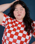 Front close up of Checker Organic Tee in Red on Ashley