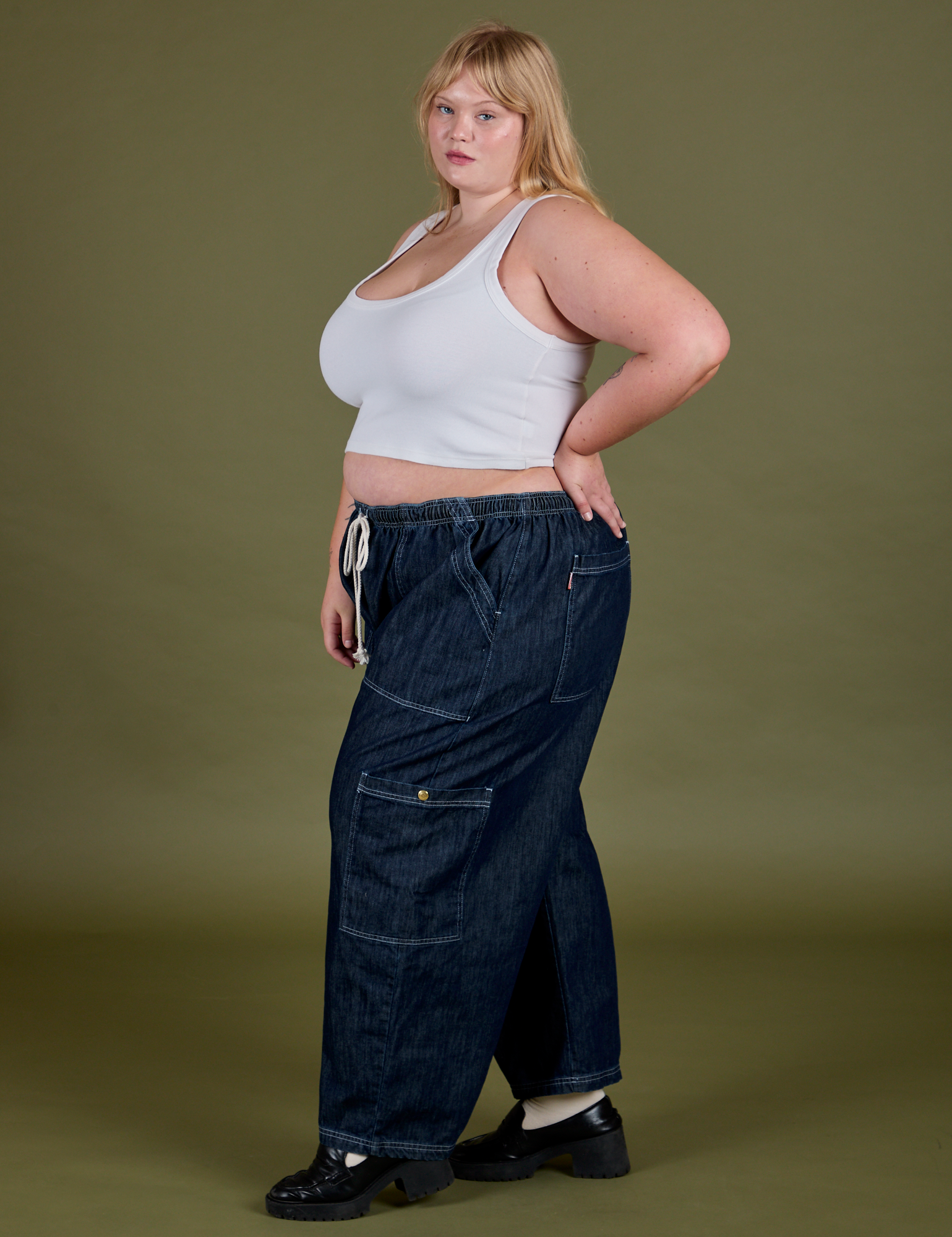 Side view of Denim Drop Pocket Pants in Dark Wash and Cropped Tank in Vintage Tee White on Juliet