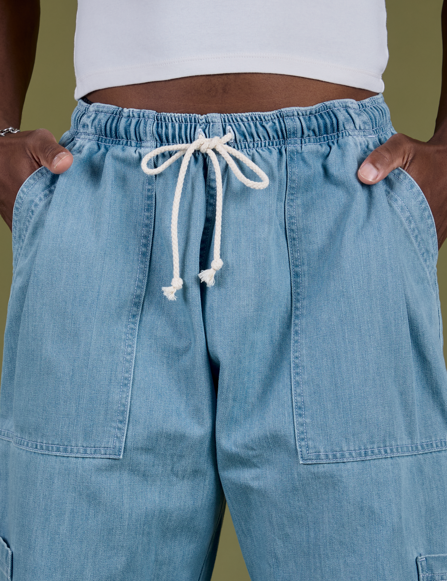 Denim Drop Pocket Pants in Light Wash front close up with Isaac's hand in both pockets