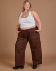 Angled front view of Drop Pocket Cargo Pants in Fudgesicle Brown and Cropped Tank in vintage tee white