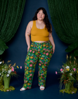 Ashley is wearing Work Pants in Pond Party and mustard yellow Cropped Tank