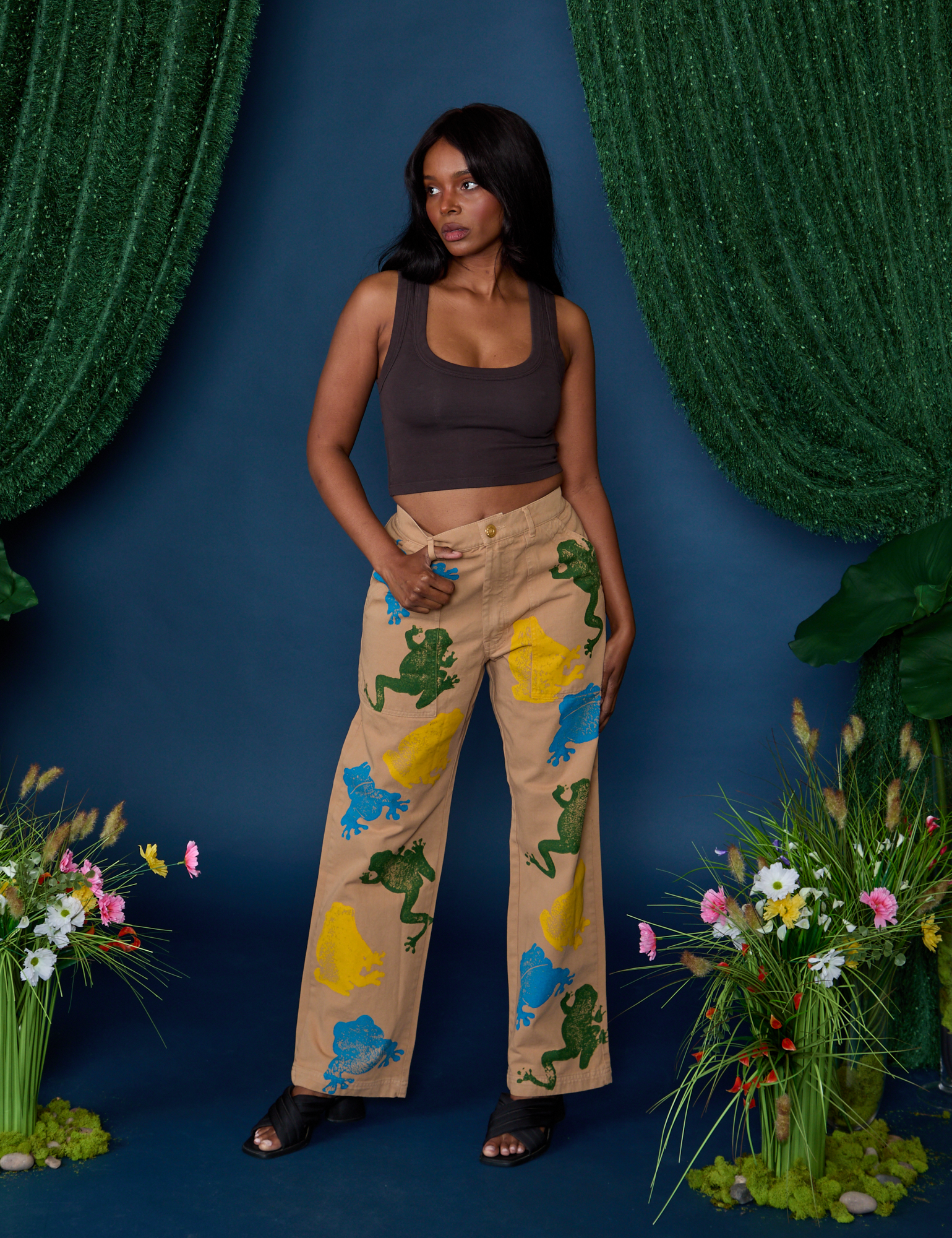 Kandia is 5'3" and wearing XS Paintstamped Work Pants in Froggy paired with espresso brown Cropped Tank