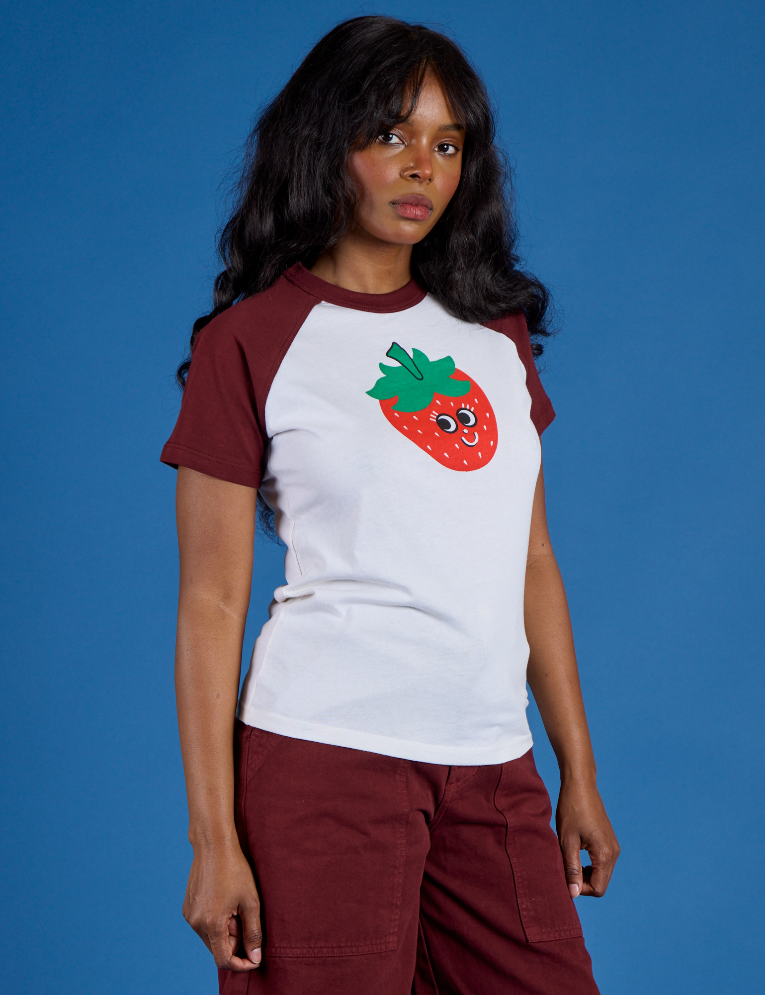 Angled front view of Produce Raglan Tee in Strawberry on Kandia