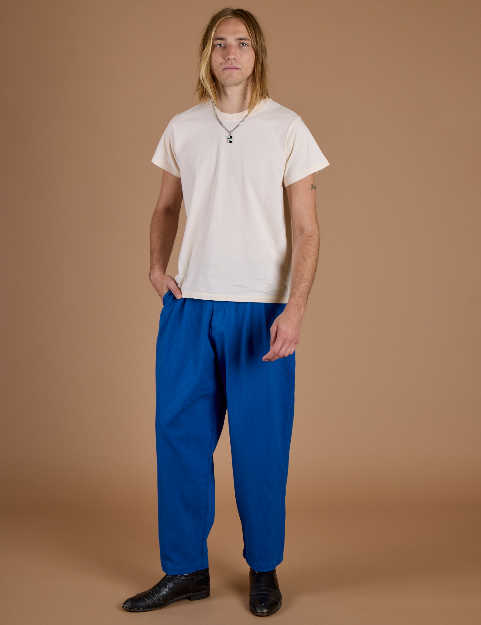 Grant is 6’5” and wearing L Heritage Trousers in Royal Blue paired with vintage off white Organic Vintage Tee