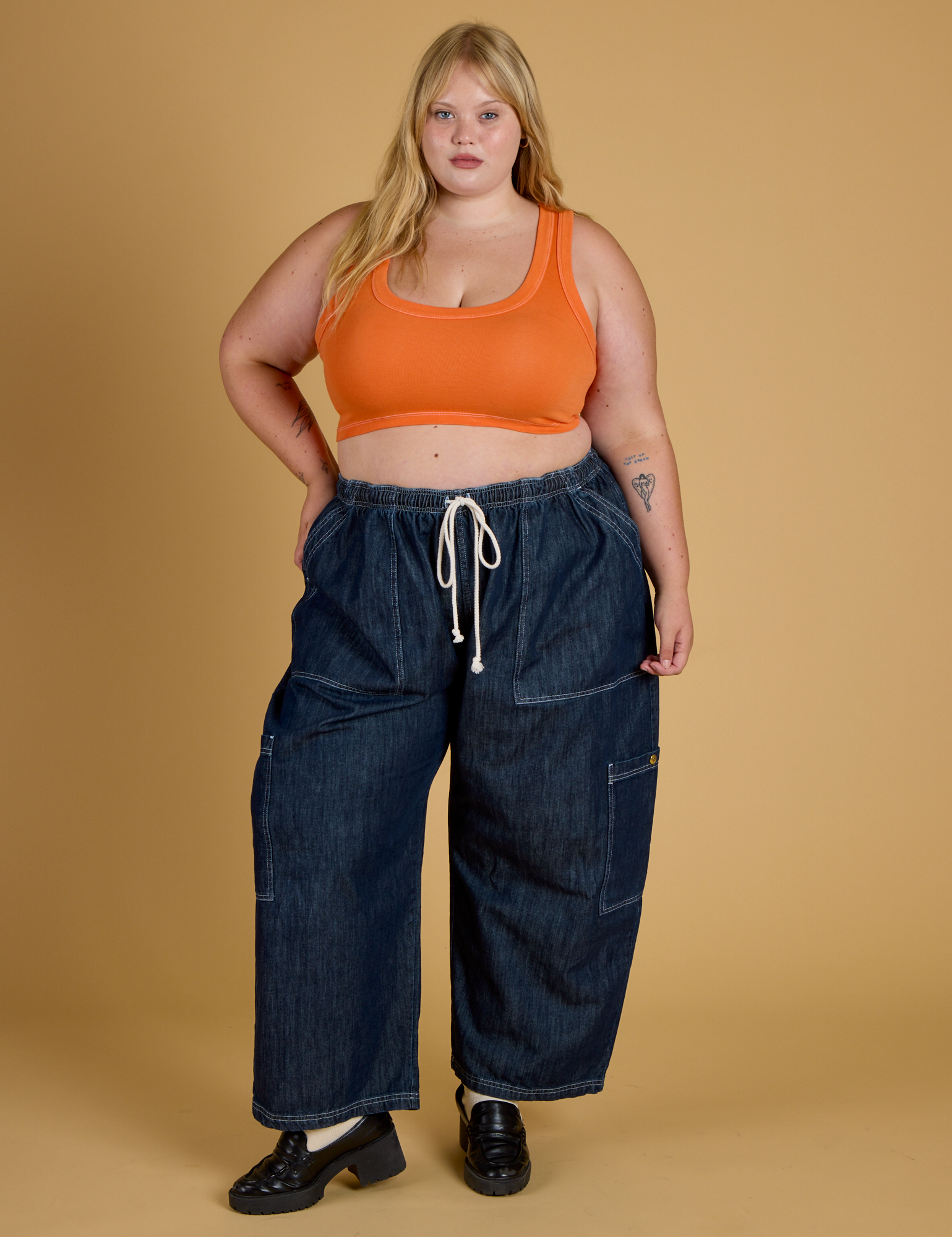 Juliet is wearing Contrast Stitch Mini Tank in Construction Orange and dark wash Denim Drop Pocket Pants