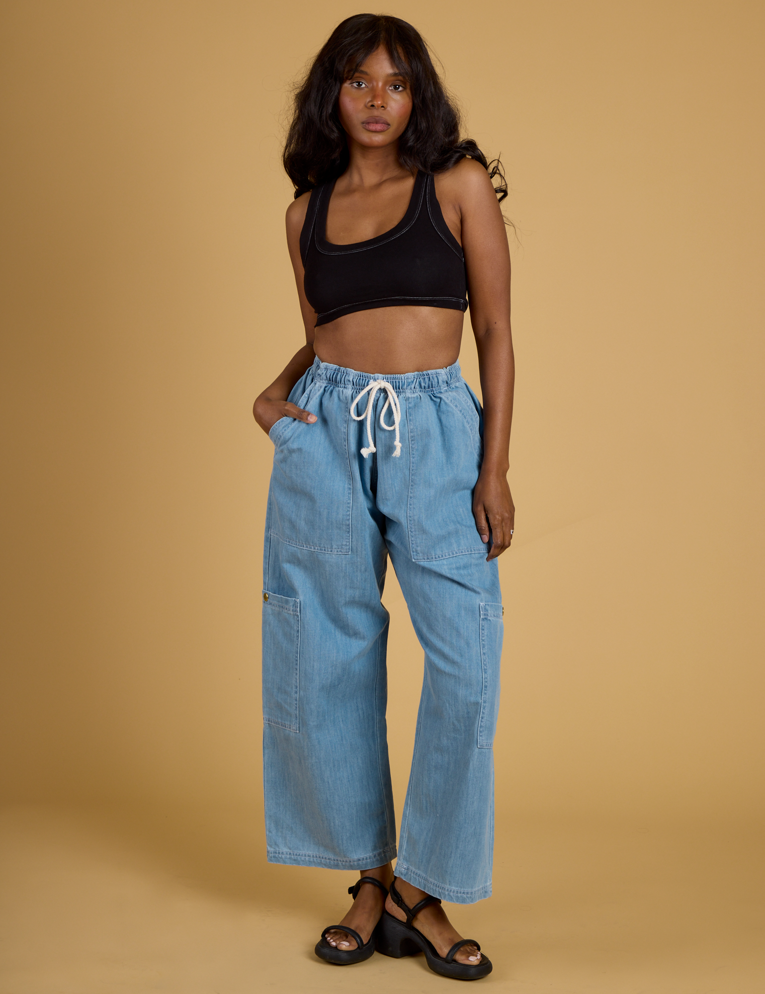 Kandia is wearing Contrast Stitch Mini Tank in Basic Black and light wash Denim Drop Pocket Pants