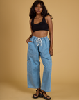 Kandia is wearing Contrast Stitch Mini Tank in Basic Black and light wash Denim Drop Pocket Pants