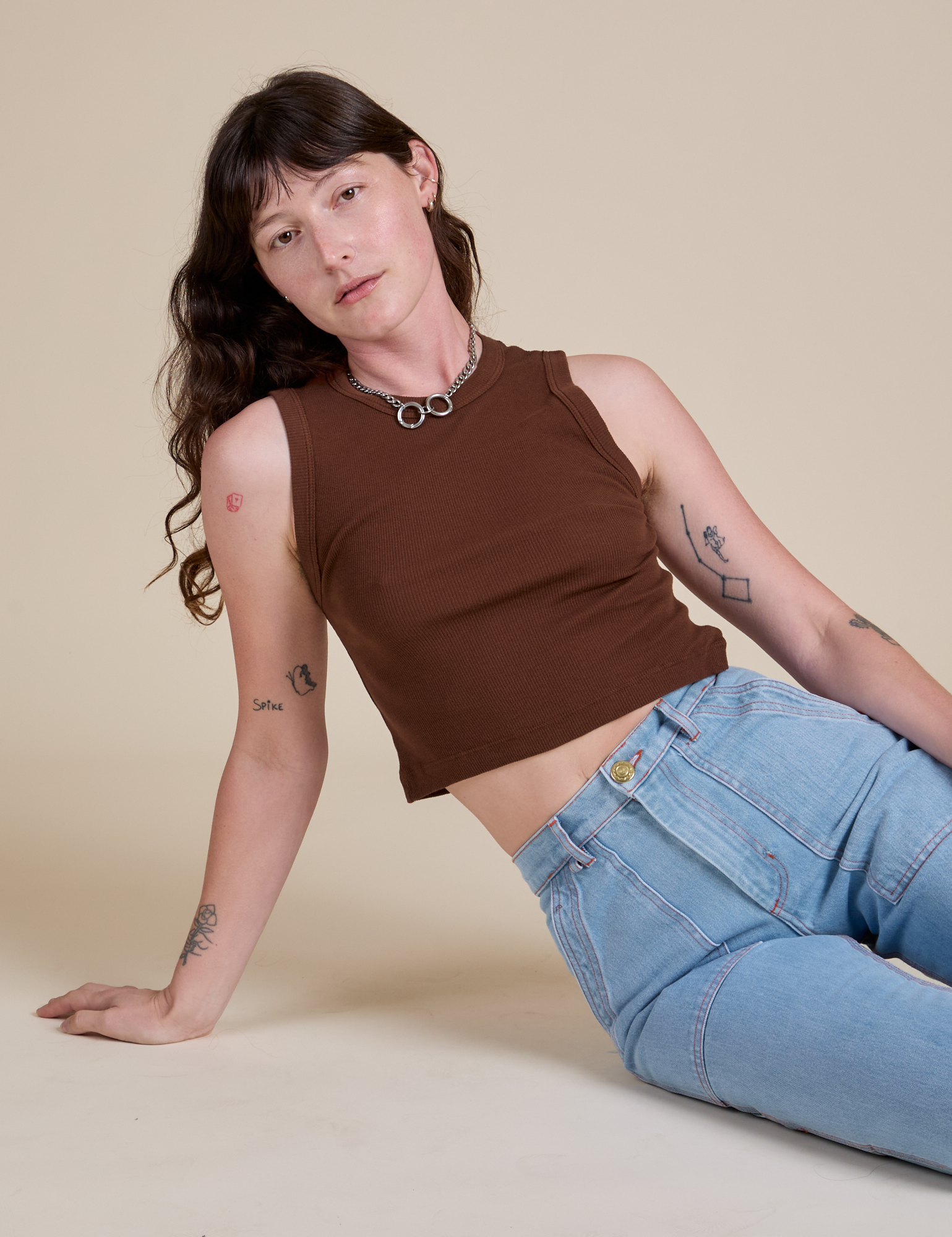 Alex is wearing Muscle Tee in Fudgesicle Brown