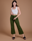 Alex is 5'8" and wearing XXS Organic Action Pants in Evergreen paired with vintage tee white Cropped Tank