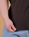 Bottom close up of Organic Vintage Tee in Espresso Brown with Ashley holding hem