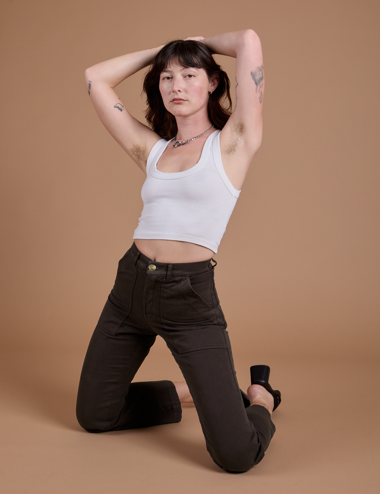 Alex is wearing Organic Work Pants in Espresso Brown and vintage tee white Cropped Tank