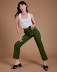 Organic Work Pants in Evergreen and vintage tee white Cropped tank on Alex